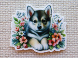 Minder of a puppy surrounded by flowers on a textured background