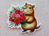 Minder of a capybara holding a bouquet of red and pink roses on a textured beige background
