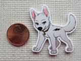 Cartoon dog minder next to a penny on a textured surface