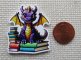 Colorful dragon minder on a textured surface with a penny for scale