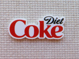 Diet Coke logo minder on a textured beige background