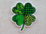 Four-leaf clover minder with green patterns on a textured beige background