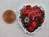 Minder with heart design and 'Cardiac Nurse' text next to a penny on a textured surface