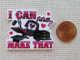 Minder with 'I CAN totally MAKE THAT' text and graduation cap design next to a penny for scale.