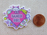 Minder with 'Gamer Girl' design next to a penny on a textured surface
