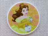 Round minder with a character from Disney's 'Beauty and the Beast' on a textured beige background