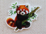 Minder of a red panda holding bamboo leaves on a textured beige background