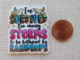 Colorful minder with motivational quote next to a penny on a textured surface