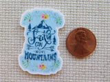 Minder with 'Faith can move mountains' text next to a penny on a textured surface
