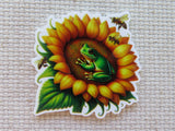 Minder of a green frog on a sunflower with bees, on a textured beige background