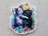 Minder of three cats hugging with flowers on a textured beige background