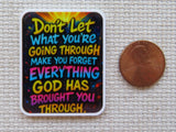 Colorful motivational minder with text next to a penny on a textured surface