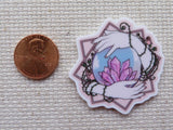 Second view of Hands Holding a Crystal Ball Needle Minder.