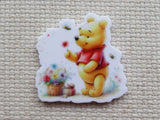 First view of Pooh is Picking a Basket of Flowers Needle Minder.