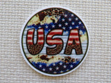 Round minder with 'USA' text and American flag design on a textured surface