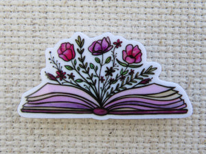 First view of Flowers Exploding from an Open Book Needle Minder.