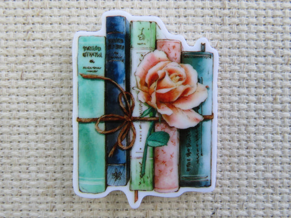 First view of A Bundle of Blue Books with a Pink Rose Needle Minder.