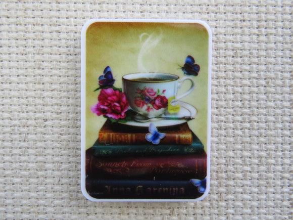 First view of A Stack of Books with a Teacup on Top Needle Minder.