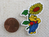 Second view of Pooh is looking up at a sunflower in amazement minder.