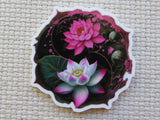 Decorative minder with pink and white lotus flowers on a textured fabric background