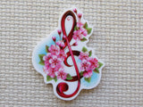 Decorative mind0er with a musical symbol and pink flowers on a textured beige background000