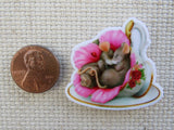Second view of pair of mice are sleeping in a teacup with a pink flower minder.