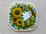 Minder with sunflowers and Easter eggs on a textured beige background