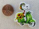 Second view of Snoopy on a Green Scooter Needle Minder.