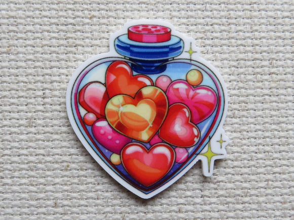 First view of A Heart Shaped Bottle of Hearts Needle Minder.