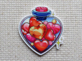 First view of A Heart Shaped Bottle of Hearts Needle Minder.