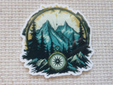 Minder with mountain and compass design on a textured beige background