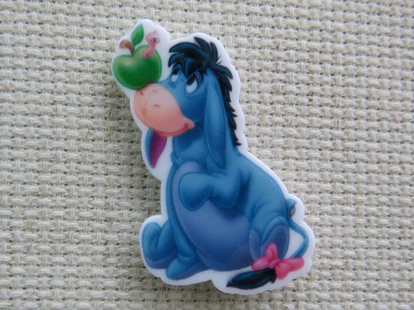 First view of Eeyore is Looking at an Apple on his Nose Needle Minder.