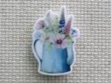 First view of Blue watering can holding fresh picked flowers needle minder.