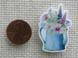 Second view of Blue watering can holding fresh picked flowers needle minder.