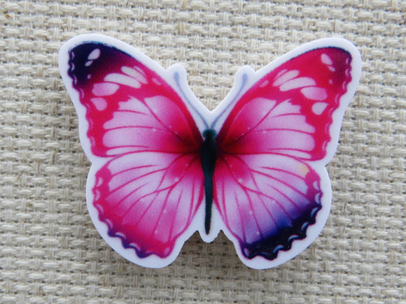 First view of  pink butterfly with dark purple wingtips minder.