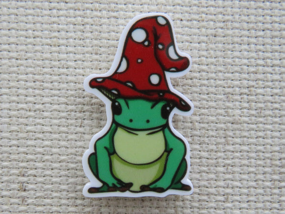 First view of Cute frog with a red and white polka dot hat on its head minder.