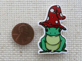 Second view of Cute frog with a red and white polka dot hat on its head minder.