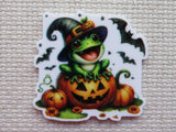 First view of Cute frog with a witch's hat sitting on top of a jack-o-lantern with bats flying around him minder.