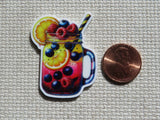 A minder depicting a mason jar filled with fruit and a striped straw, shown next to a U.S penny.
