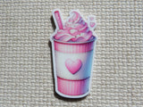 A minder depicting a pink and white soft-serve drink in a striped cup with a heart emblem.