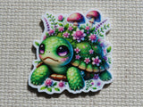 A minder featuring a cute green cartoon turtle surrounded by pink flowers and mushrooms.