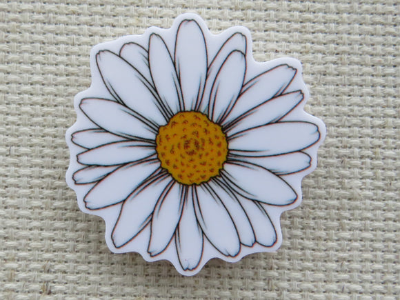 First view of a white daisy needle minder.