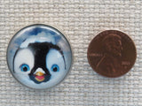 Second view of Cute penguin face in a domed minder.