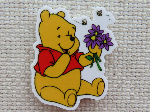 First view of Pooh Bear with Purple Flowers Needle Minder.