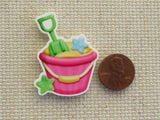 Second view of Pink Pail with a Green Shovel Needle Minder.