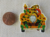 Second view of a gnome surrounded by an abundance of sunflowers in the back of this yellow truck minder.