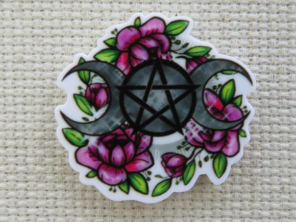 First view of A pair of moons and pretty flowers surround this pentagram minder.