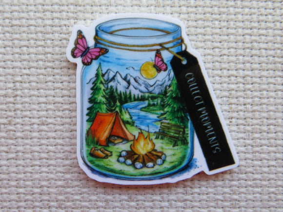 First view of Beautiful tent camping scene with a campfire next to a river in the mountains, all in a jar with the tag 