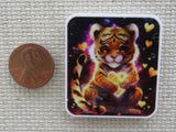 Second view of a golden colored tiger cub  surrounded by hearts minder.