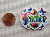 Second view of the word "teacher" in a rainbow of colors with colorful butterflies around minder.